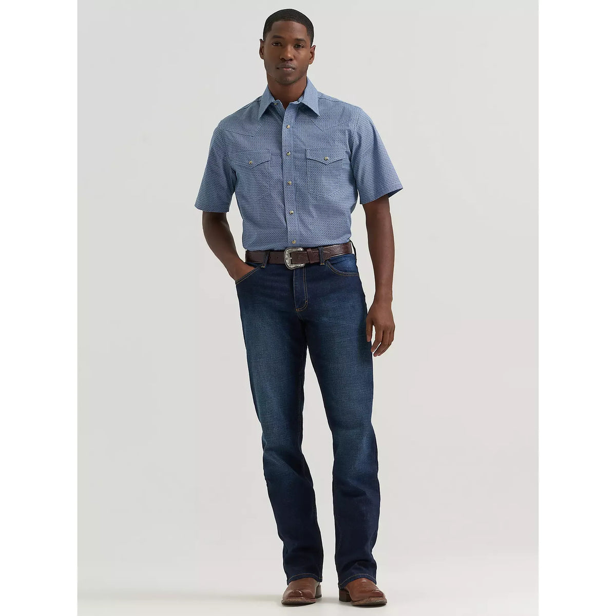 Man modeling Wrangler 20X Active Flex Regular fit Twilight jeans with stretch denim.