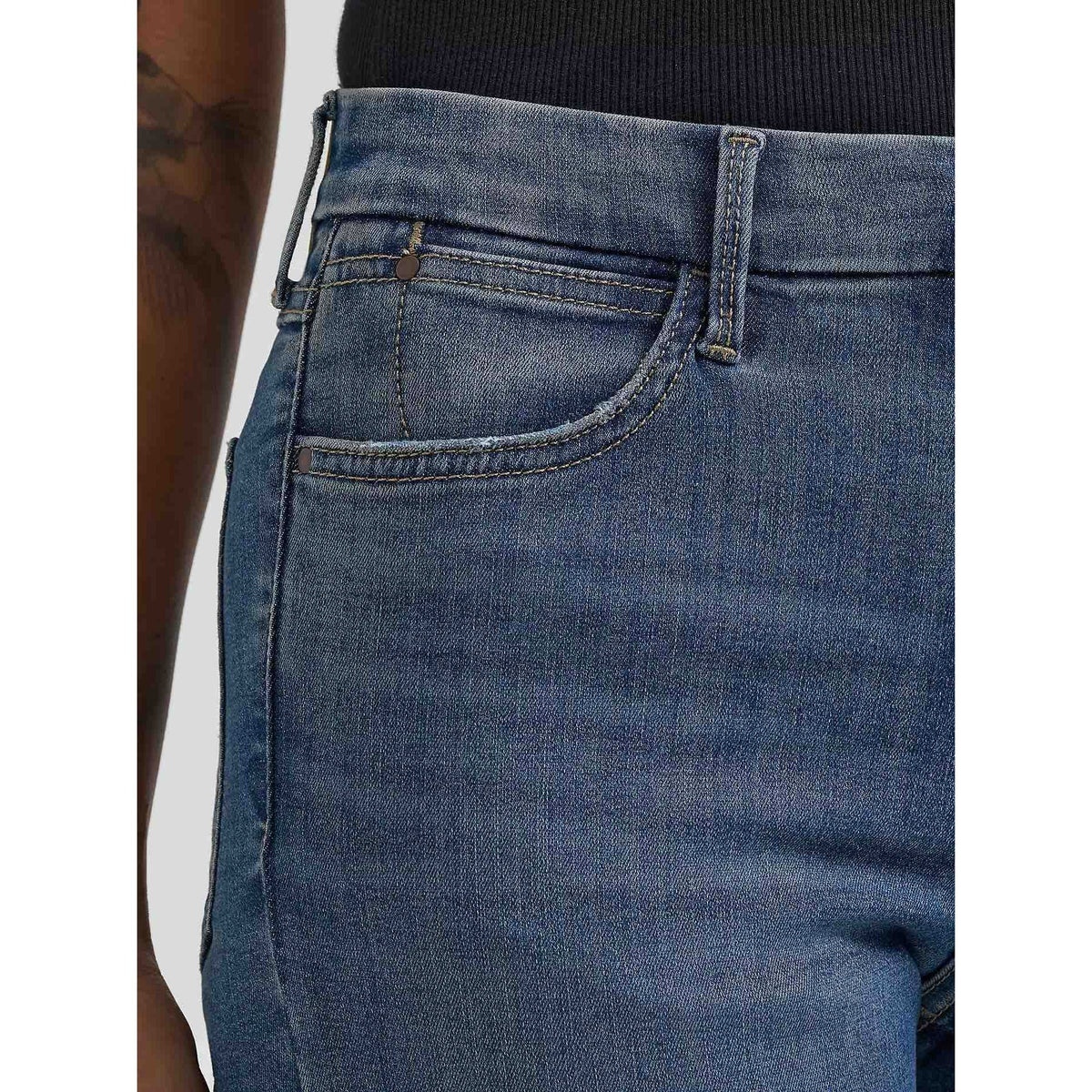 Wrangler Bespoke Flare in Lily denim jeans, close-up of high-rise waist with belt loops and front pocket.