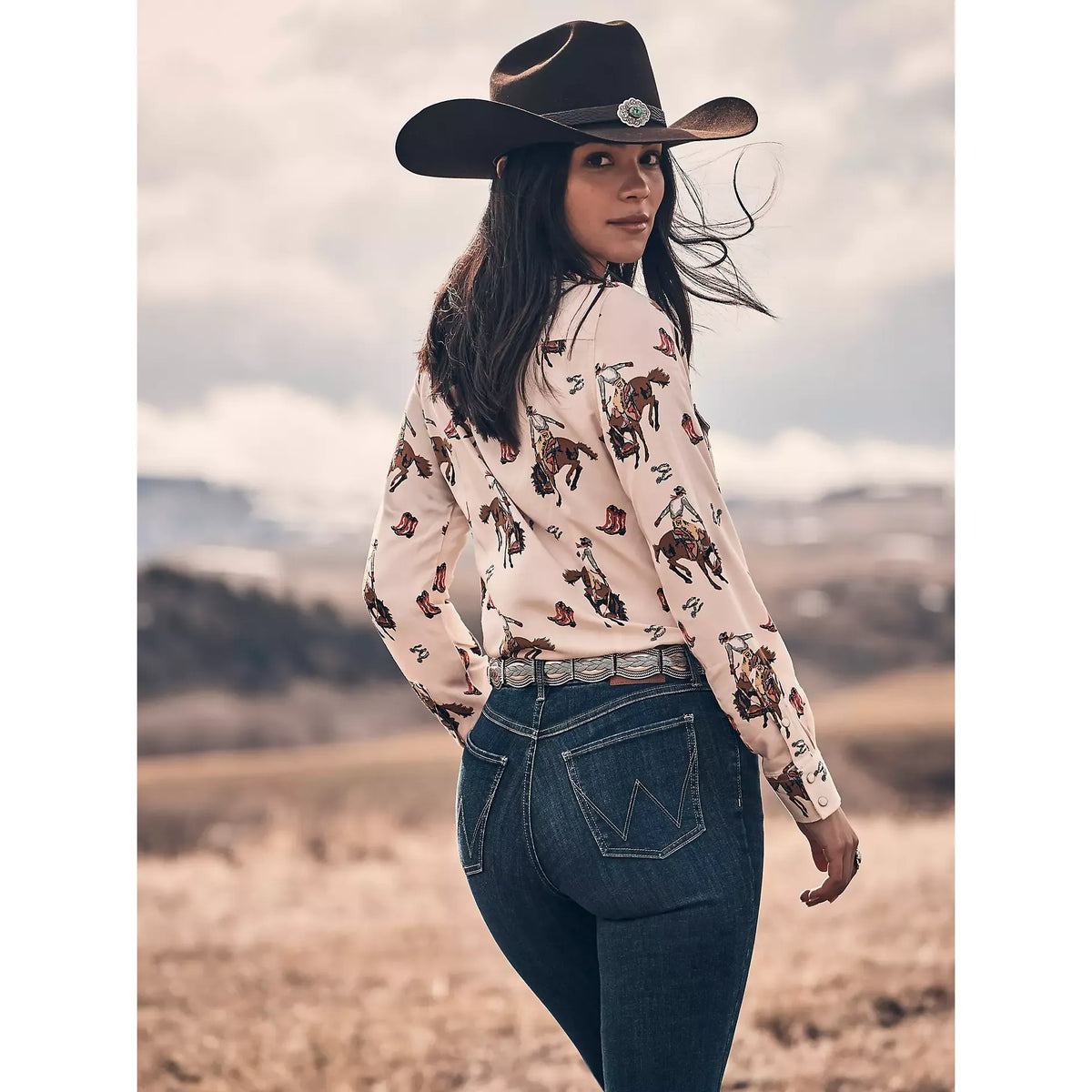 Woman wearing Wrangler Bespoke Trouser in Alexandra: high-rise denim with vintage fit, voluminous below knee.