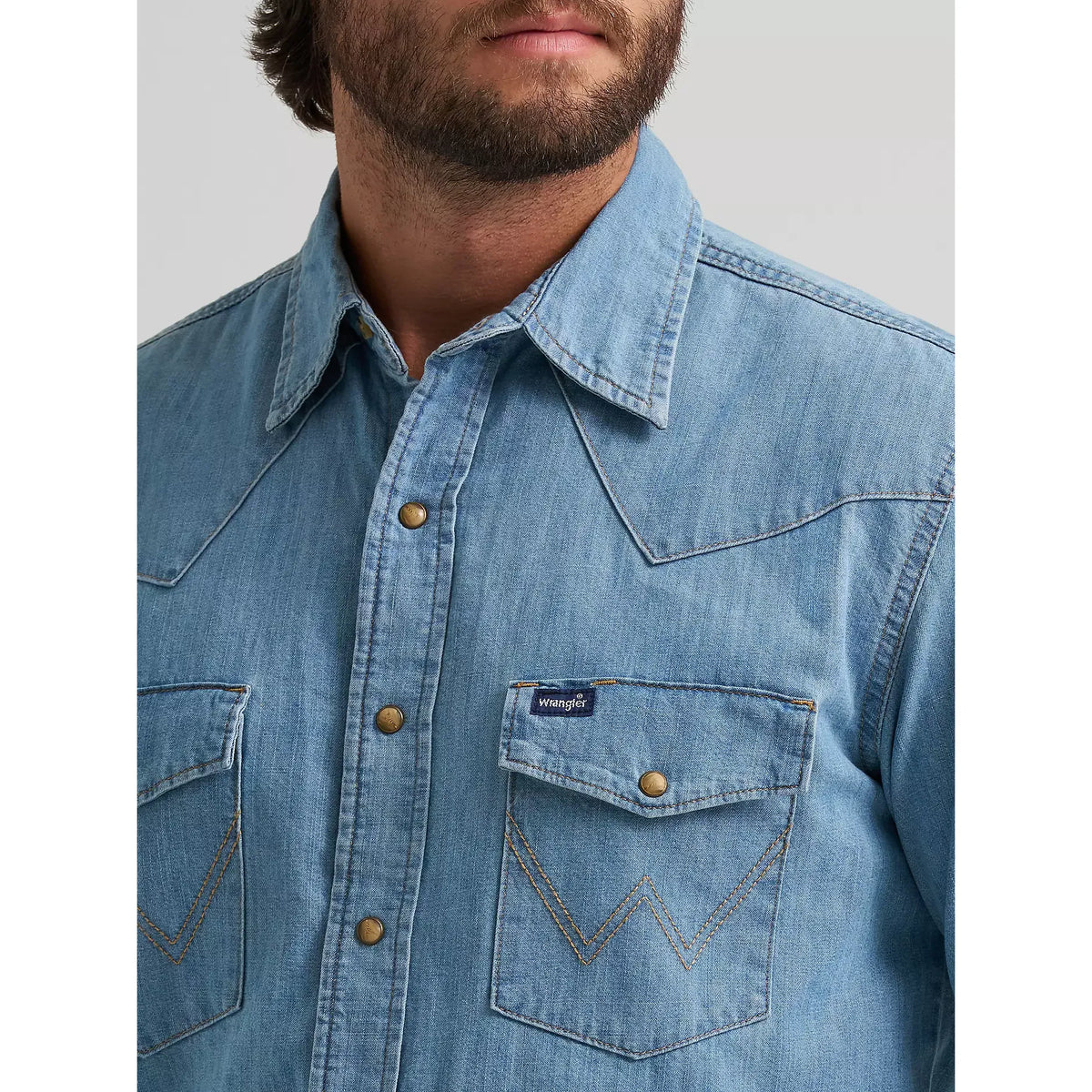 Wrangler Classic Denim Snap Shirt in light wash with brass snaps and heritage-inspired W stitching on pockets.