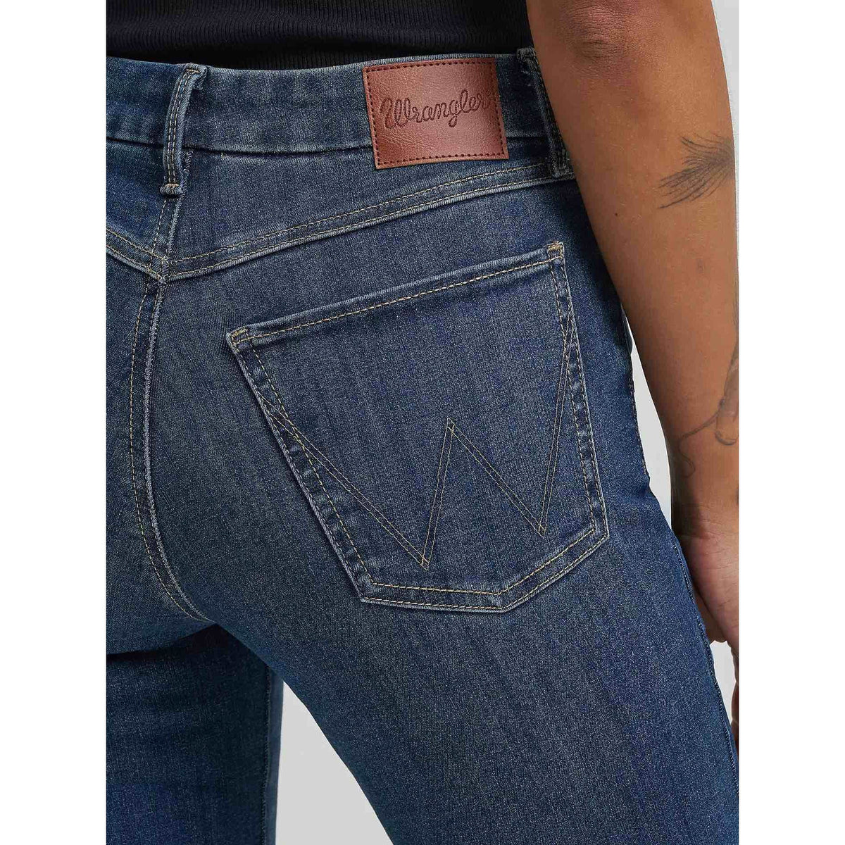 Wrangler Bespoke Bootcut in Lacey jeans with leather logo patch on waistband and back pocket stitching.