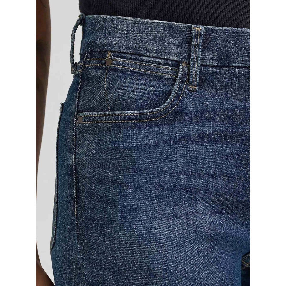 Wrangler Bespoke High-Rise Bootcut jeans in Lacey; close-up of contoured waistband and front pocket.