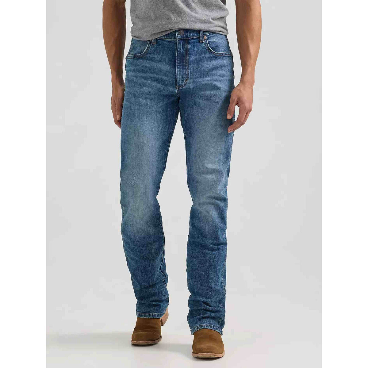 Wrangler Western Retro Slim Bootcut Jeans in Harris wash worn by a model, front view with brown boots.