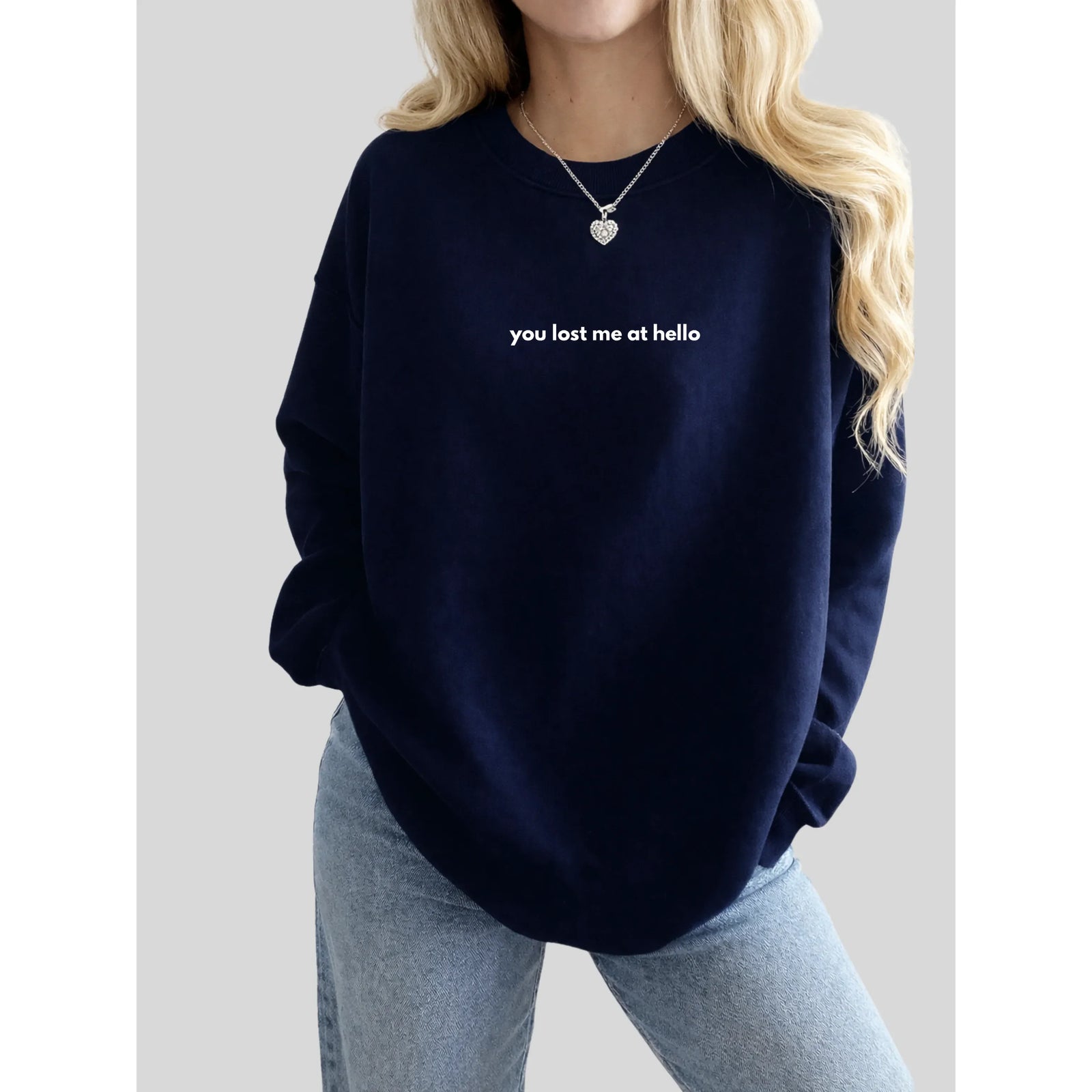 Navy You Lost Me at Hello Cozy Crew sweatshirt with white lowercase slogan on front, paired with light-wash jeans.