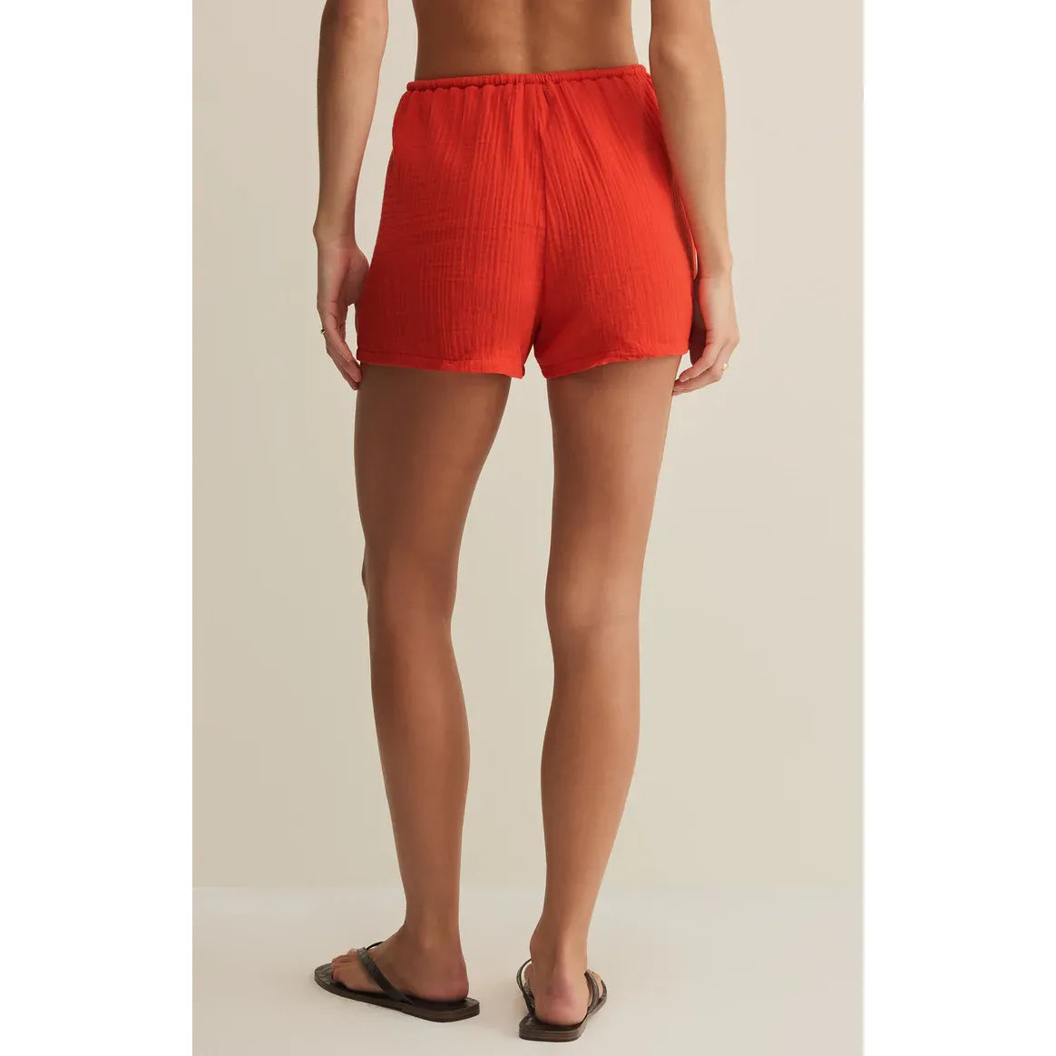 Back view of red Z Supply Daylight Airy Shorts on model, relaxed crinkle cotton with drawstring waist and pockets.