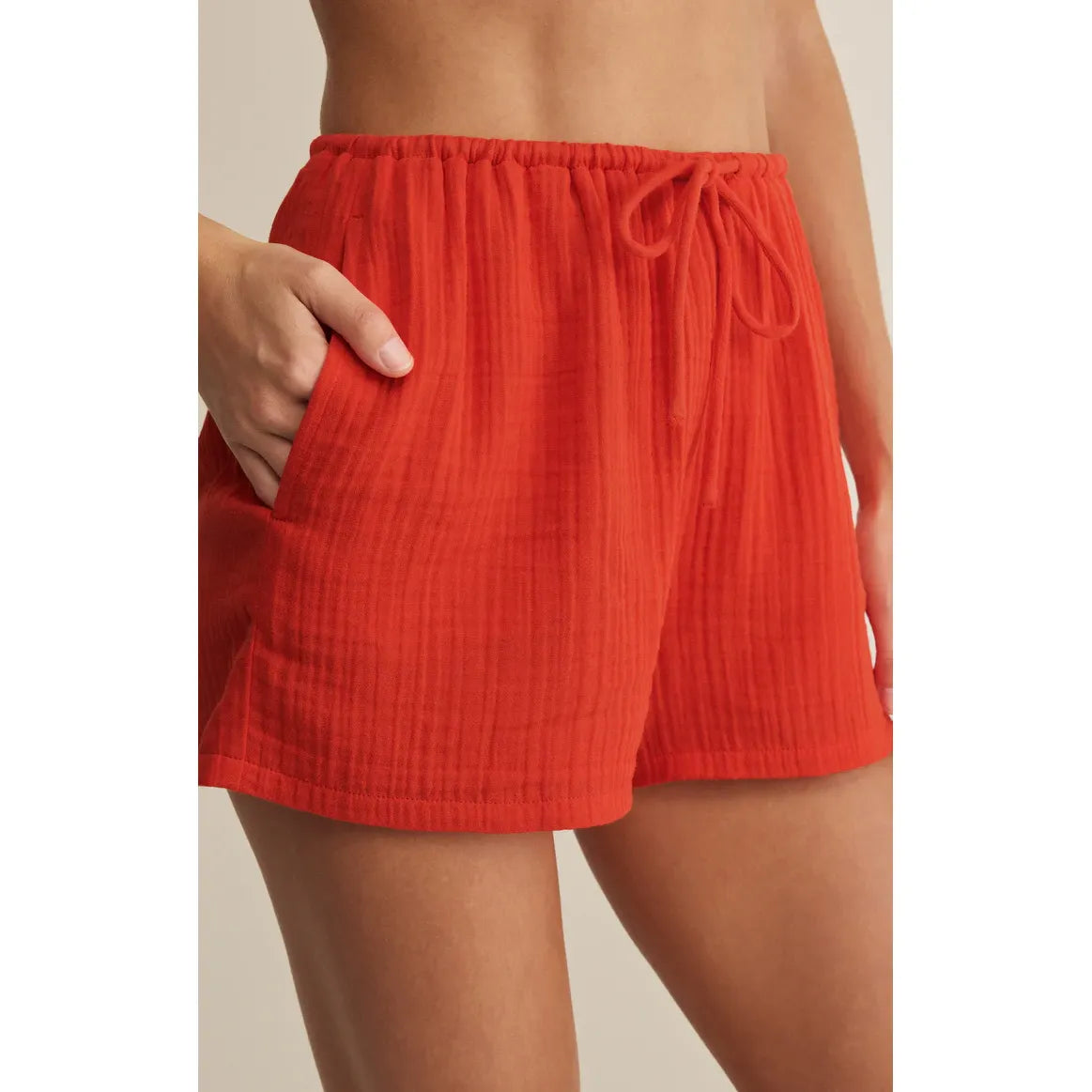 Z Supply Daylight Airy Shorts in coral with drawstring, pockets, lightweight crinkle cotton.