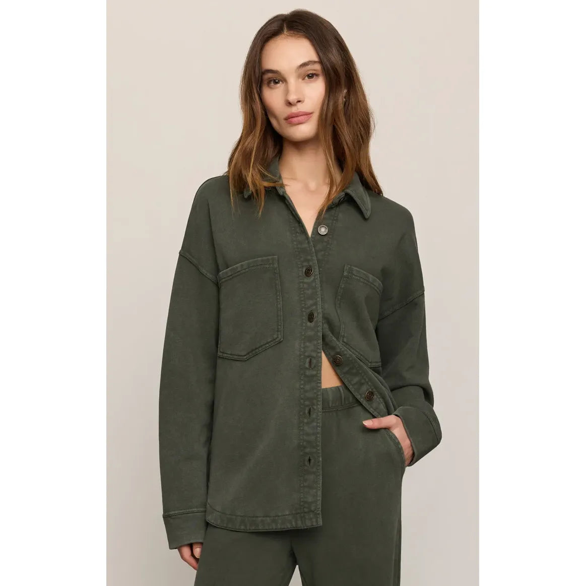 Olive green vintage-inspired knit jacket with button front, chest pockets, and relaxed fit for a timeless, effortless look.