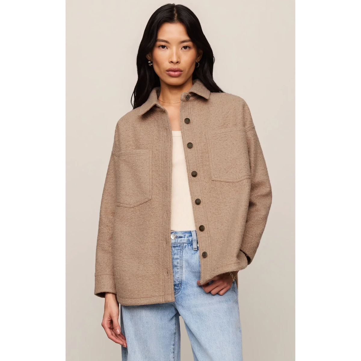 Camel knit shacket with structured collar, button front, and textured fabric. Cozy fall jacket paired with blue jeans.