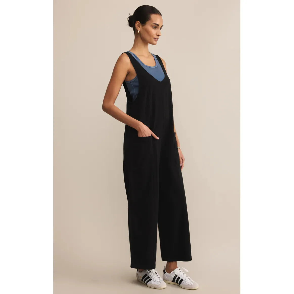Z Supply Brasilia Everyday Jersey Jumpsuit on model; black relaxed-fit jumpsuit with wide straps and pockets.