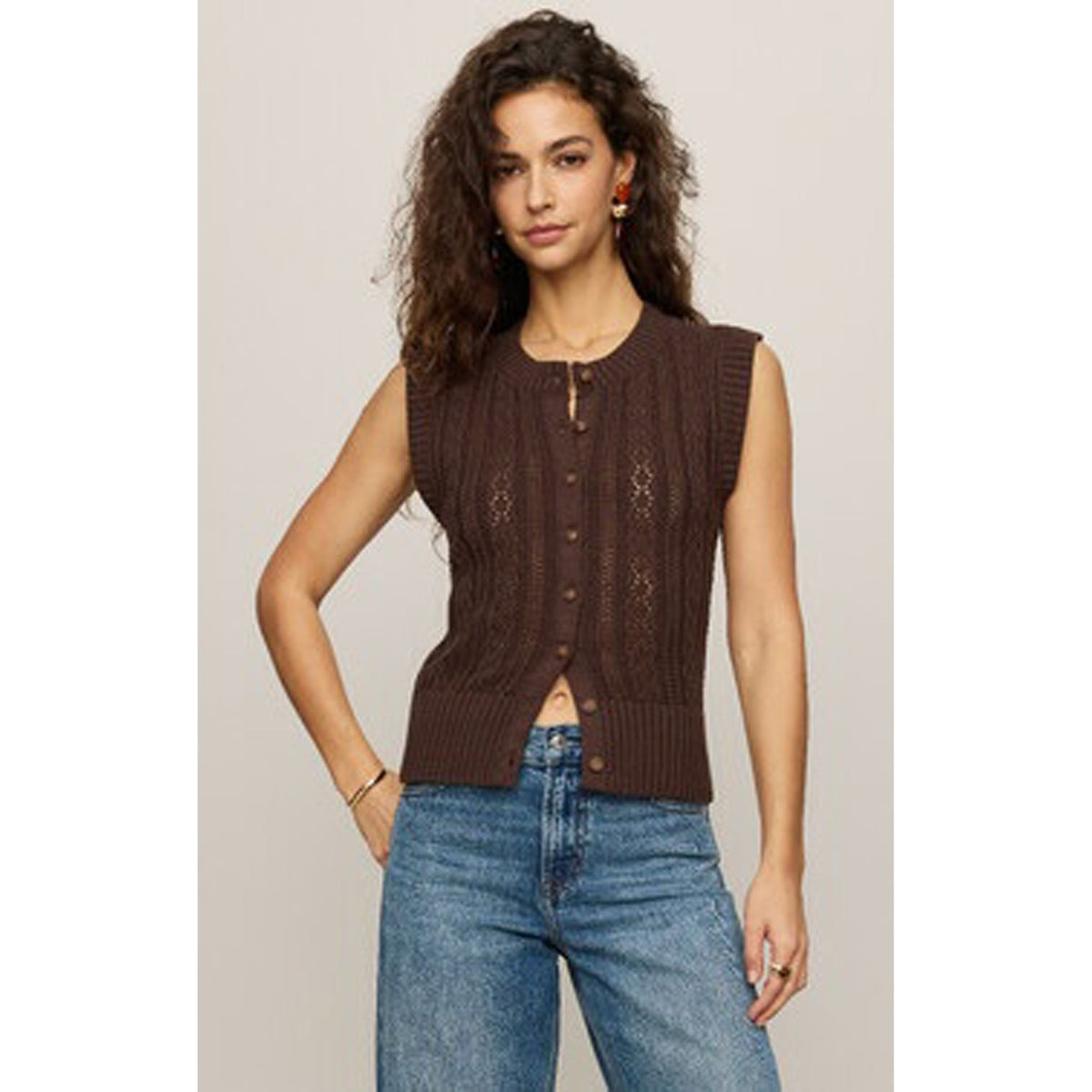 Cabot Sweater Vest in brown cotton-blend, textured vertical-knit with faux horn buttons, paired with jeans.