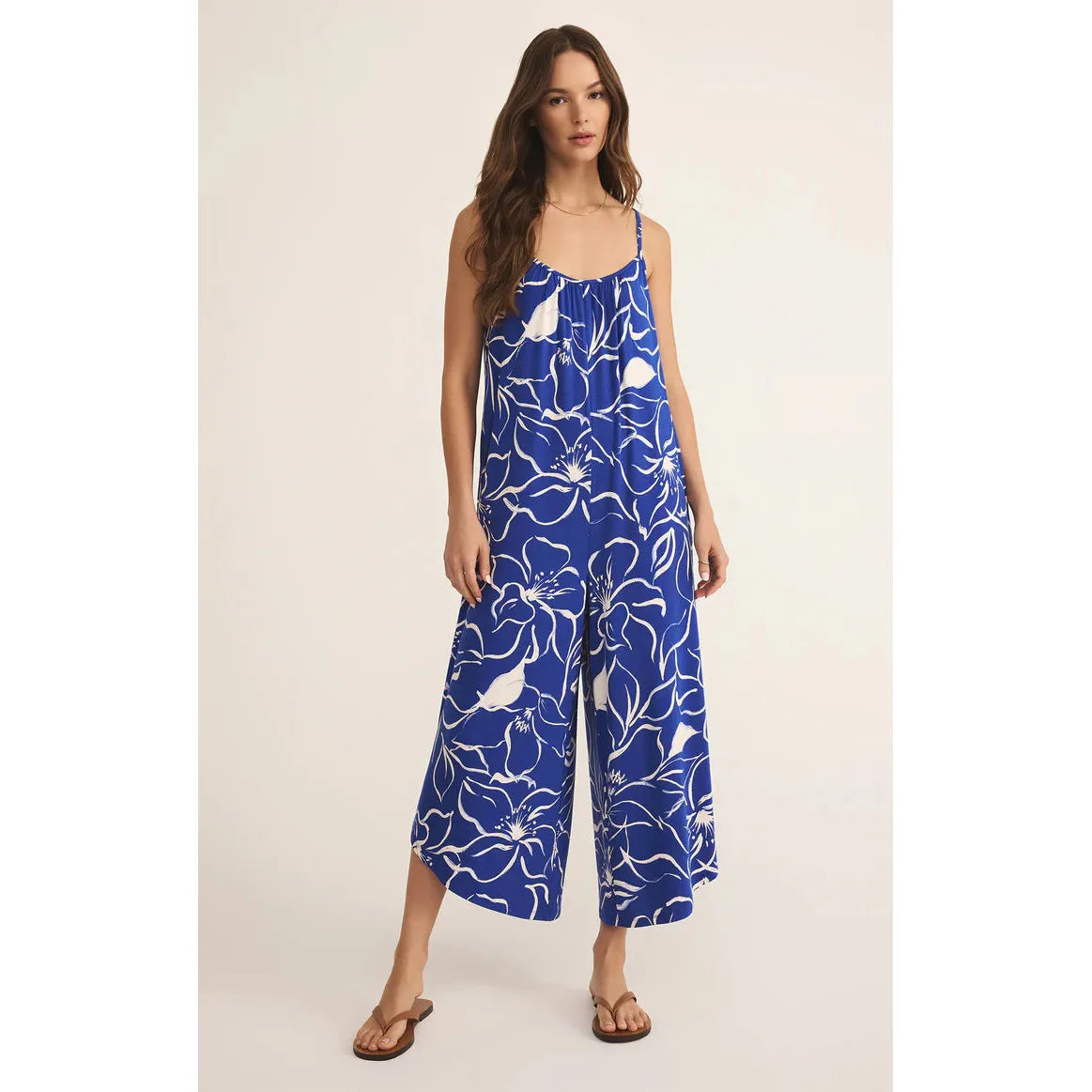 Z Supply Cala Floral Jumpsuit features a bold print, flared cropped leg, and adjustable straps for effortless style.