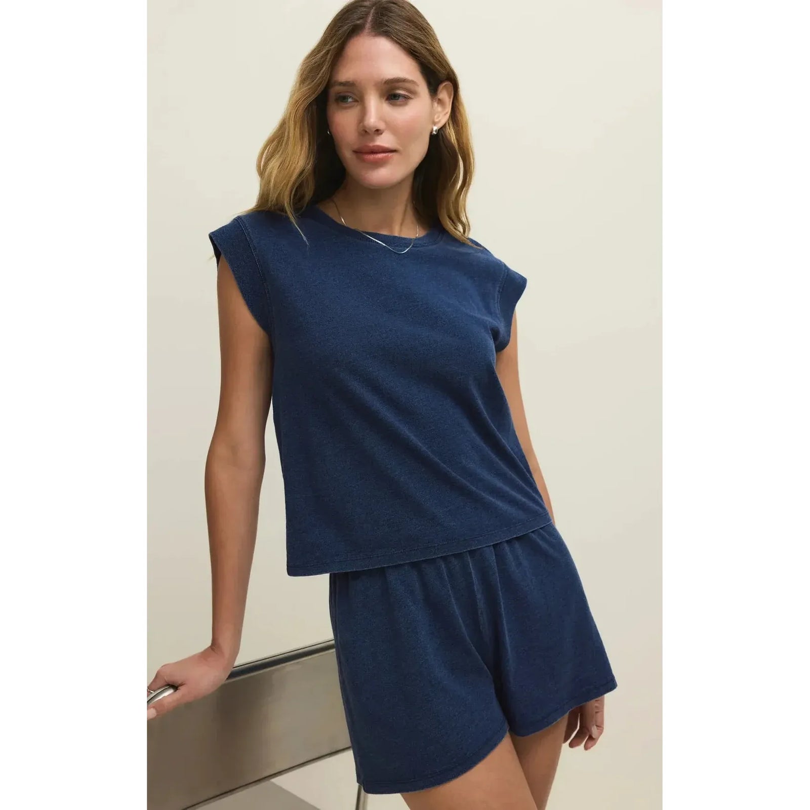 Model wearing navy Camino Jersey Top; fitted crew neck, breathable cotton-lyocell blend.