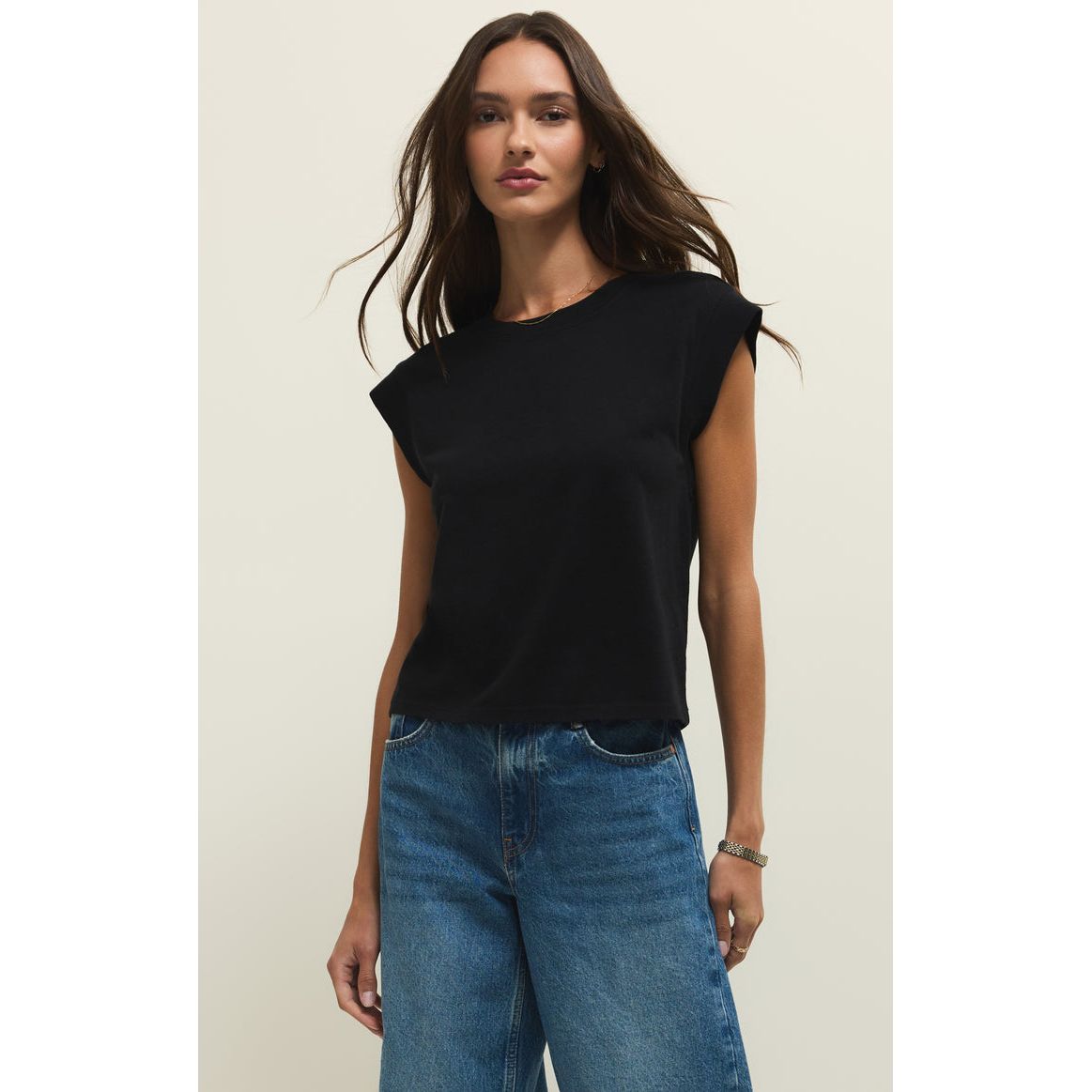 Model wearing Z Supply Camino Jersey Top in black with relaxed crewneck and statement sleeves, paired with blue jeans.