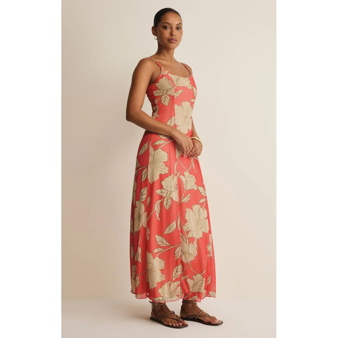 Z Supply Charisma Bloom Midi Dress in coral tropical floral print with adjustable straps on a model.