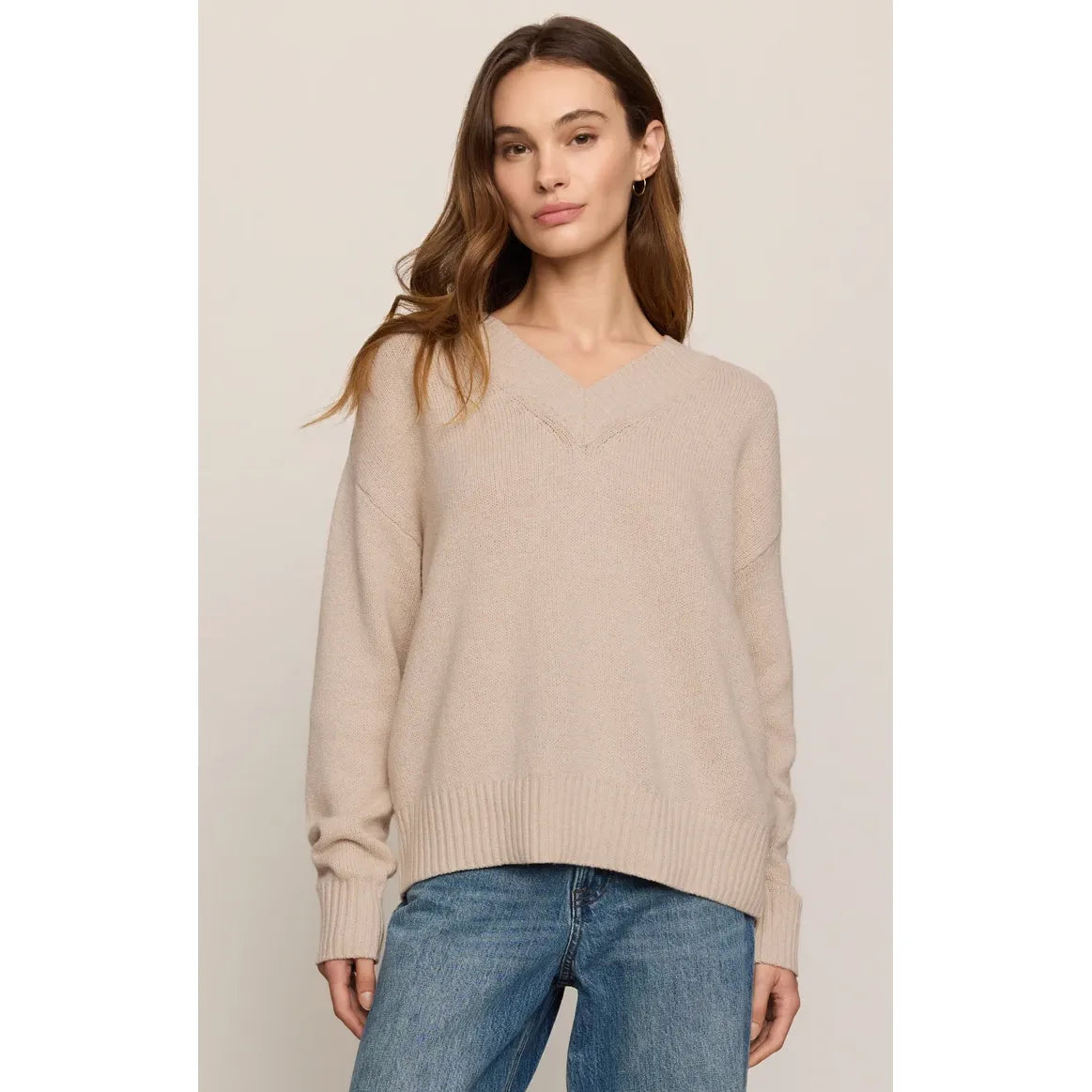 Model wearing a frosted pearl Z Supply Cloud Spun V-Neck Sweater with relaxed fit, ribbed cuffs, and lightweight knit.