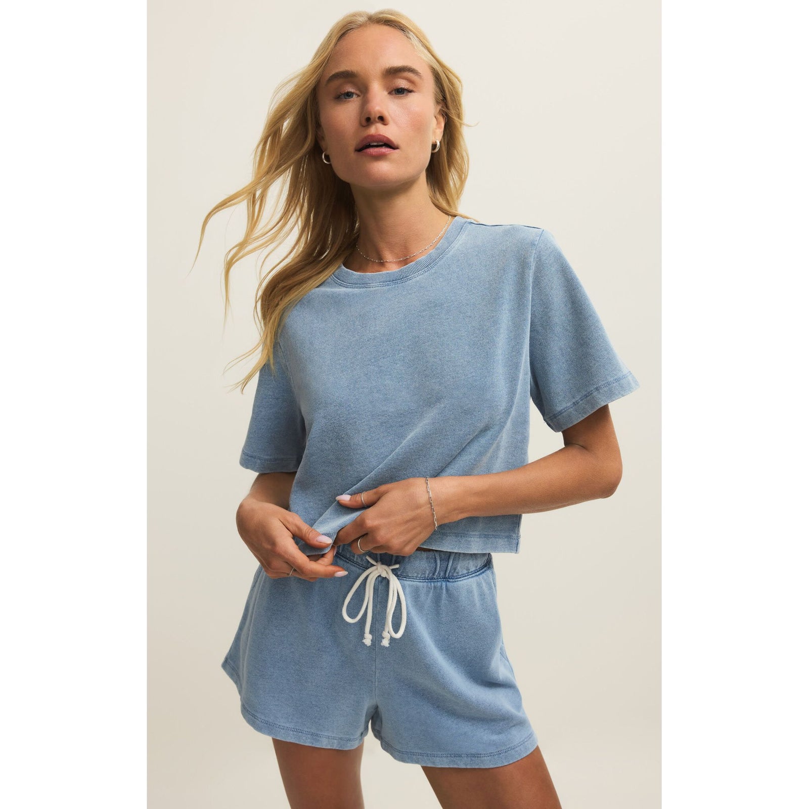 Z Supply Curran Denim Sweatshirt in light blue, relaxed crew-neck knit worn with matching shorts.