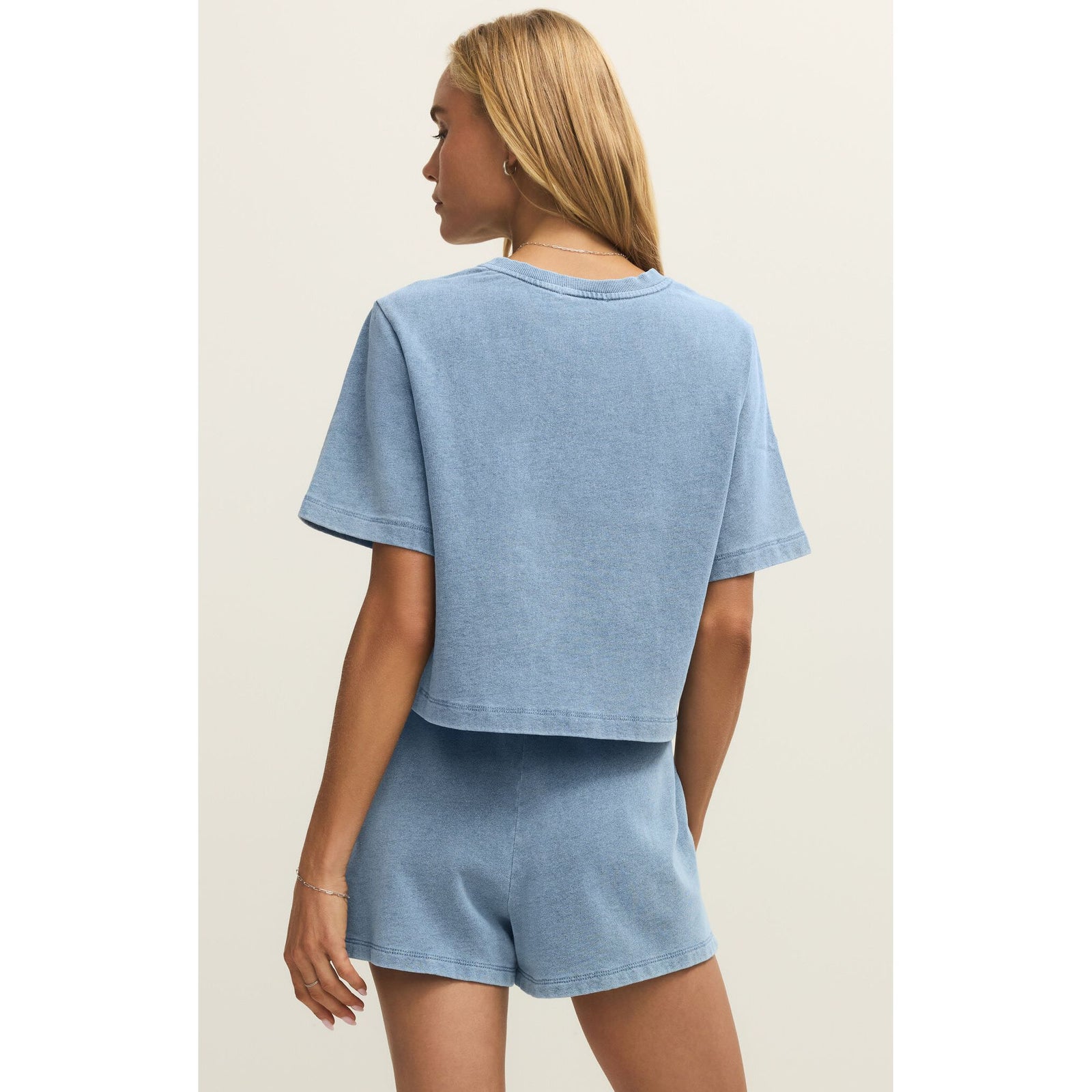 Z Supply Curran Denim Sweatshirt in light blue, relaxed crew-neck knit worn with matching shorts.