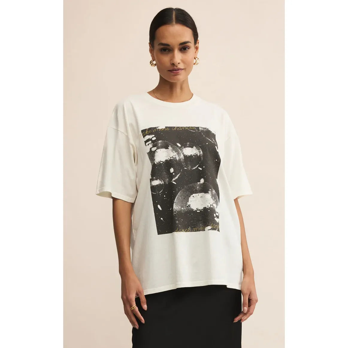Model wearing Z Supply Dance More Dance City Tee, white oversized crew-neck with black graphic print.