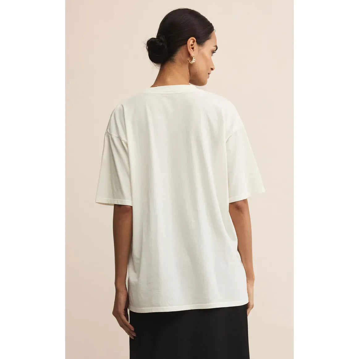 Back view of a model wearing white Z Supply Dance More Dance City Tee in relaxed-fit cotton jersey with a vintage wash.