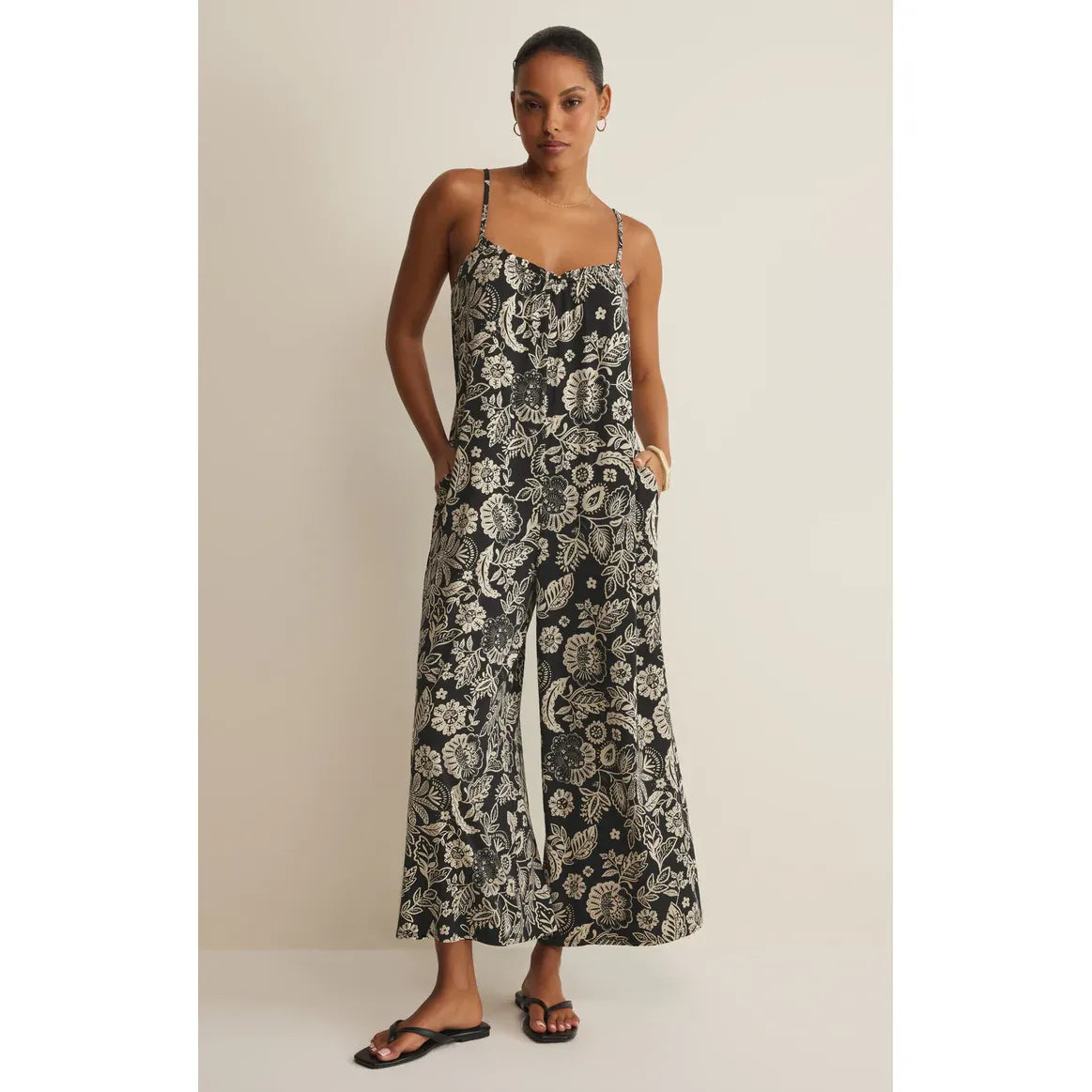 Z Supply Day Off Luz Jumpsuit in black floral print with thin straps and wide-leg silhouette.