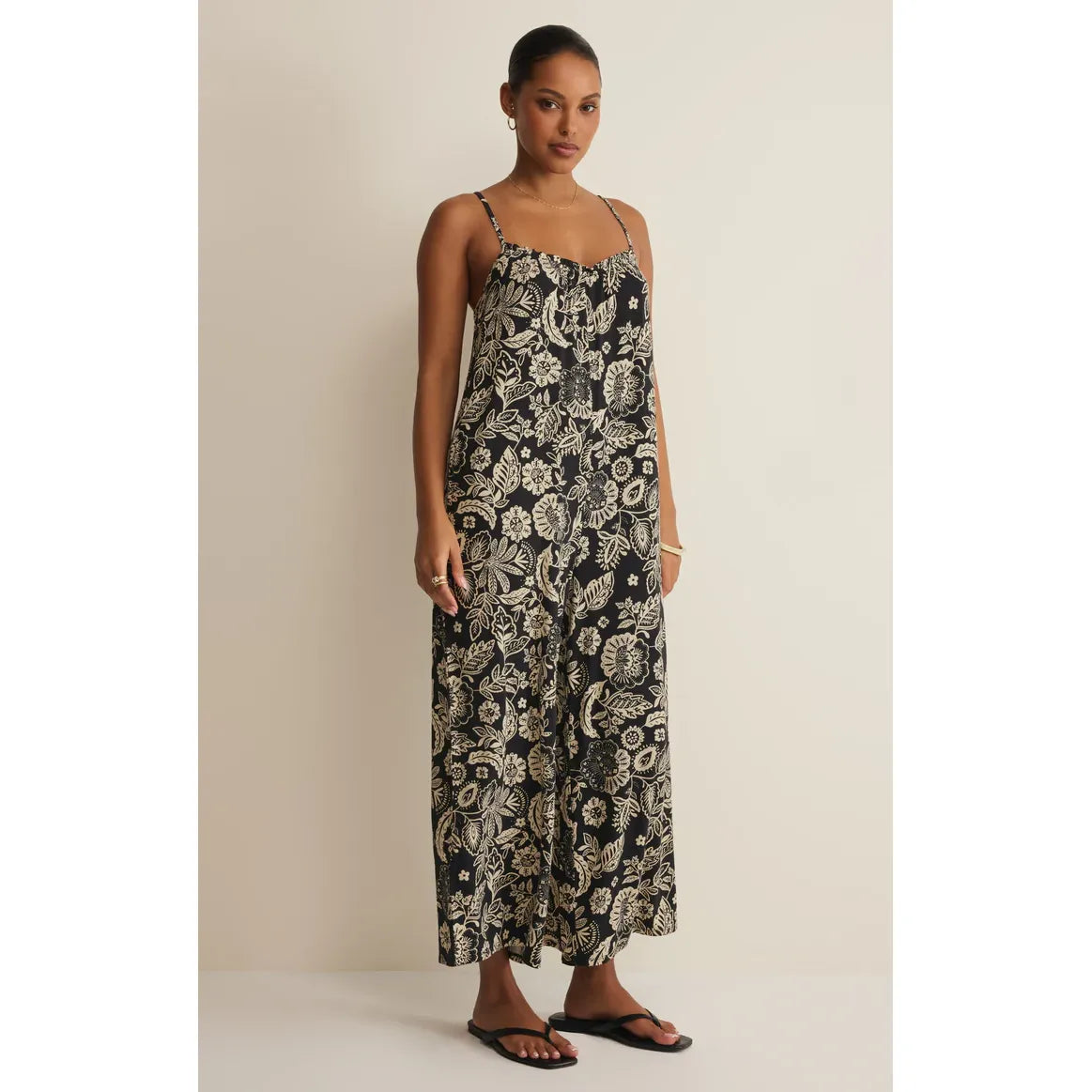 Z Supply Day Off Luz Jumpsuit in black floral print with thin straps and wide-leg silhouette.