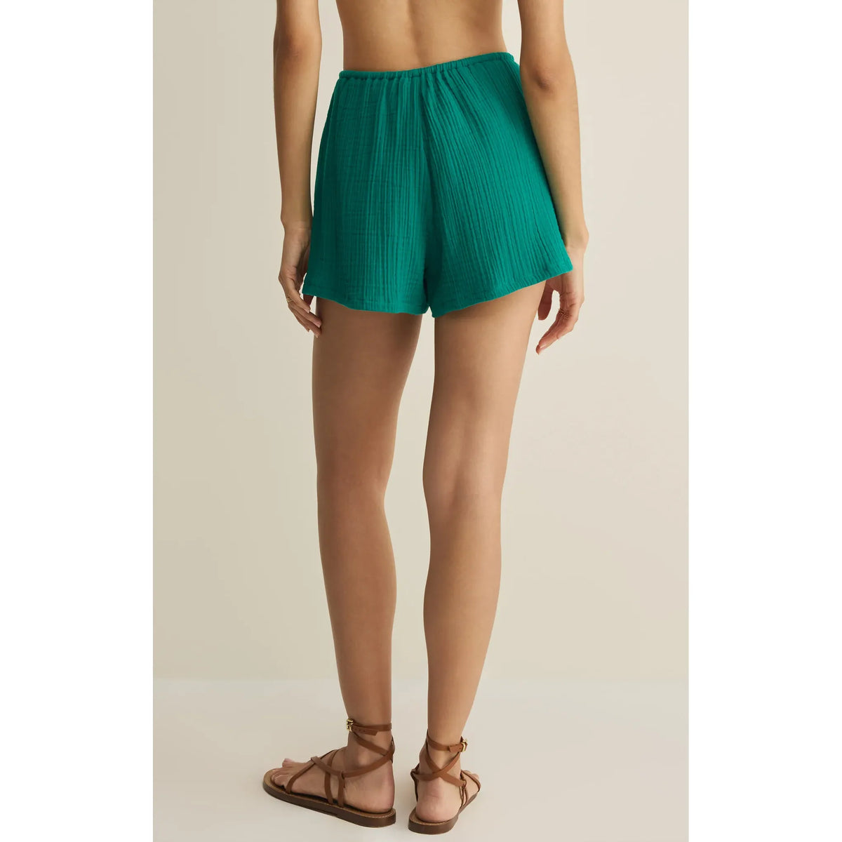 Back view of teal Daylight Airy Shorts with elastic waistband, drawstring, and side pockets.