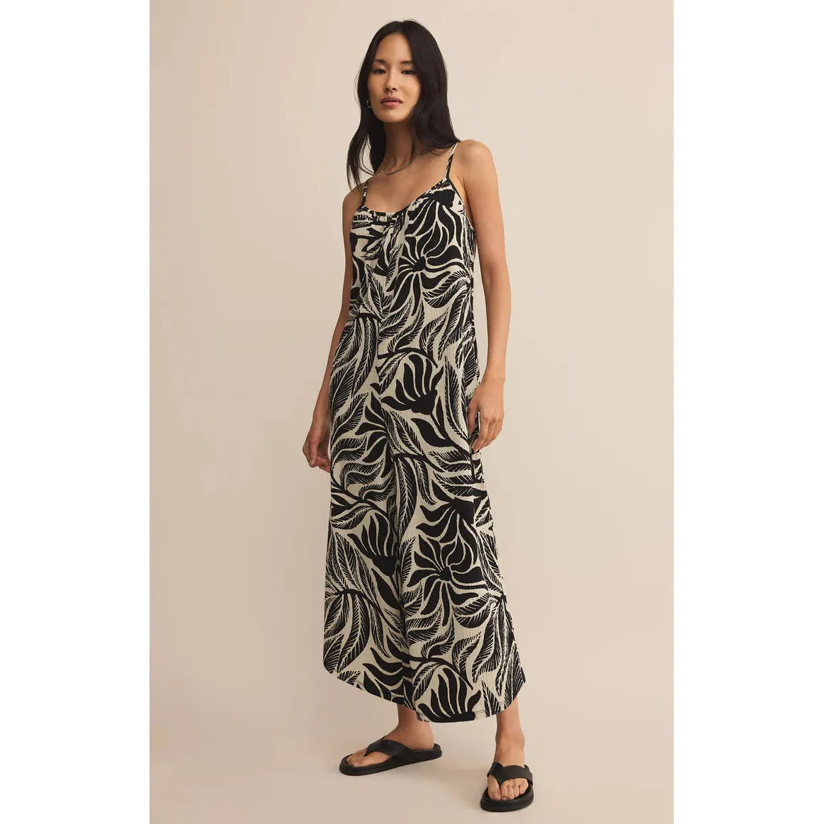 Z Supply Flared Palm Jumpsuit black-and-cream tropical palm print, airy gauze wide-leg silhouette with sandals