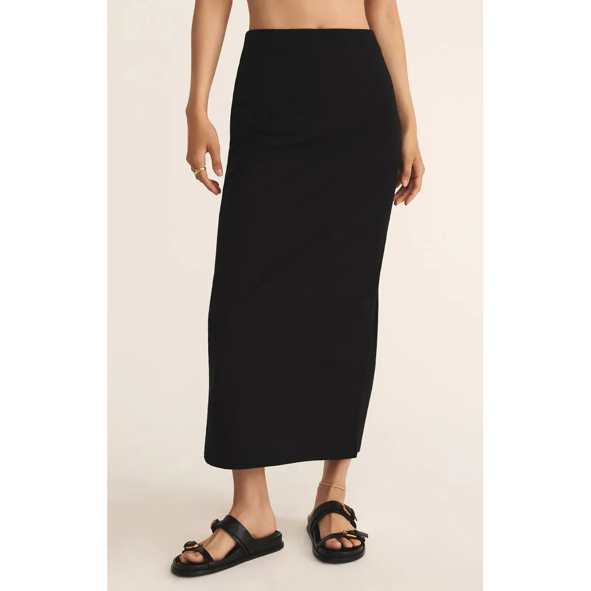 Z Supply Gail Jersey Denim Midi Skirt in true black on model, elastic waist, flowing cotton-jersey midi with sandals