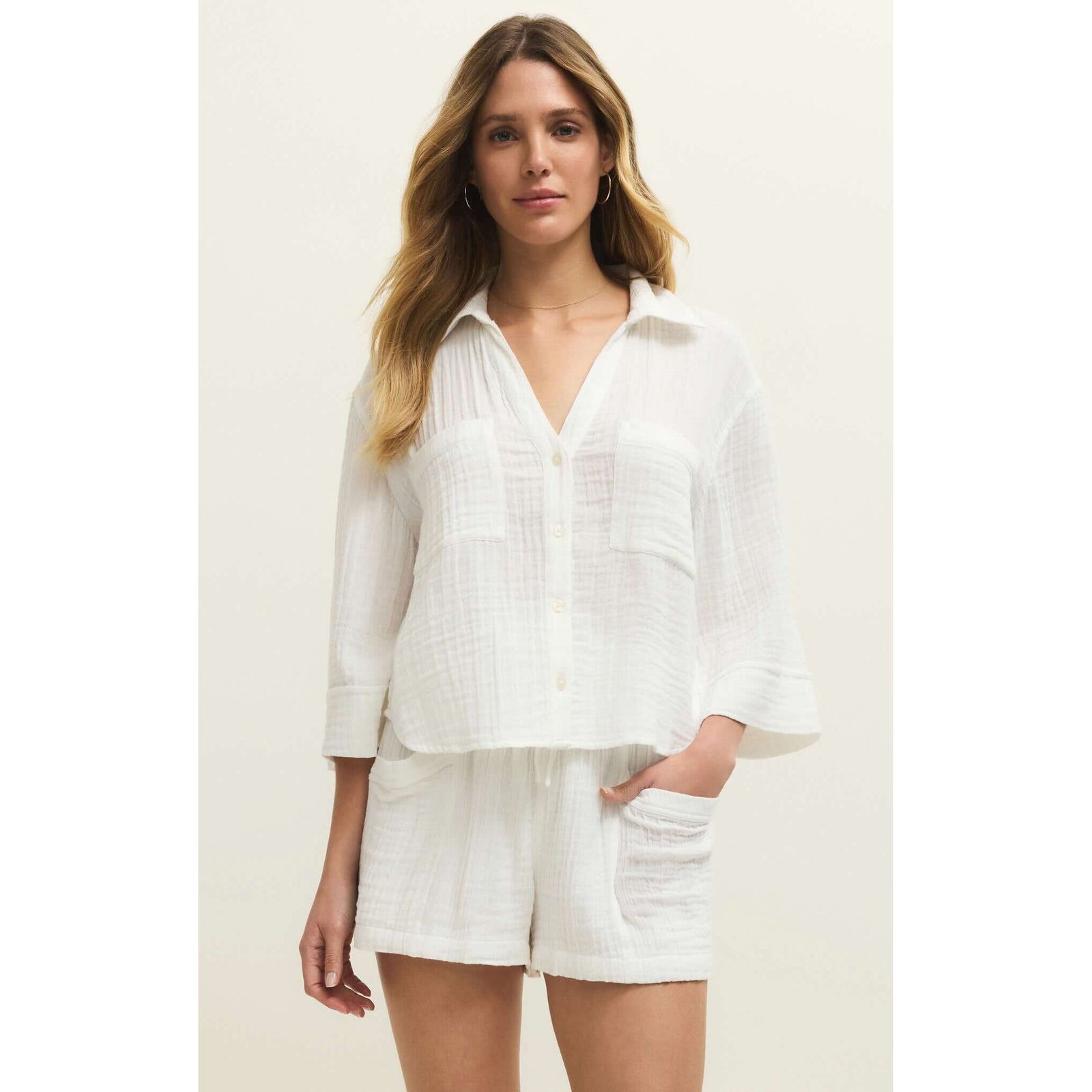 Z Supply Helena Shirt on a model: white textured button-down with relaxed fit and front pockets.