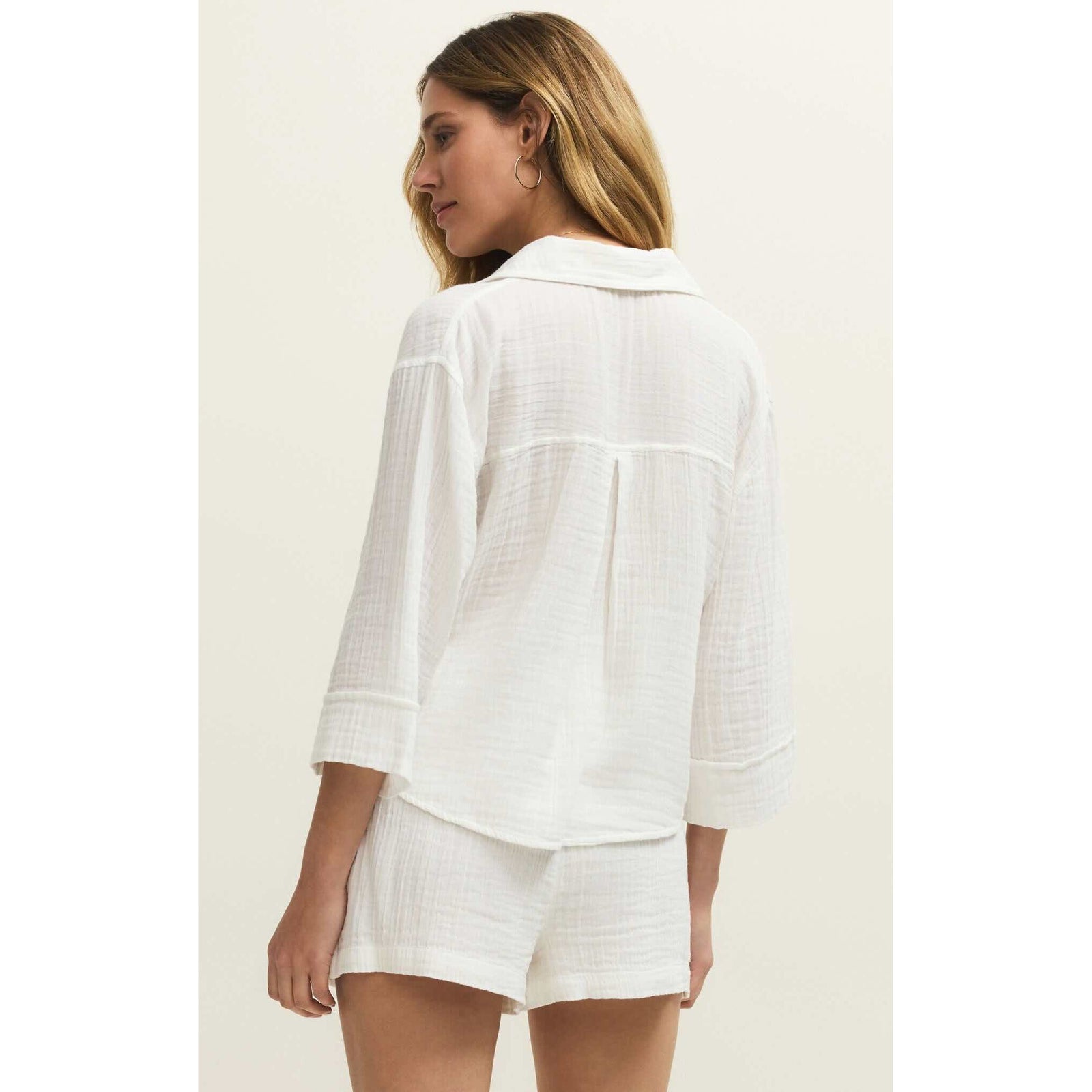 Z Supply Helena Shirt on a model: white textured button-down with relaxed fit and front pockets.