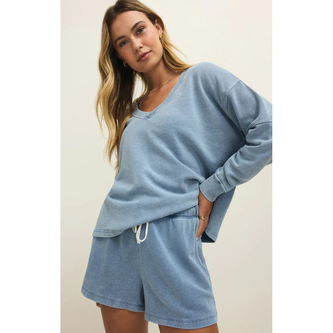 Model wearing light blue Z Supply Hunter Knit Denim Shorts with a high-rise fit, drawcord waist, and slash pockets.