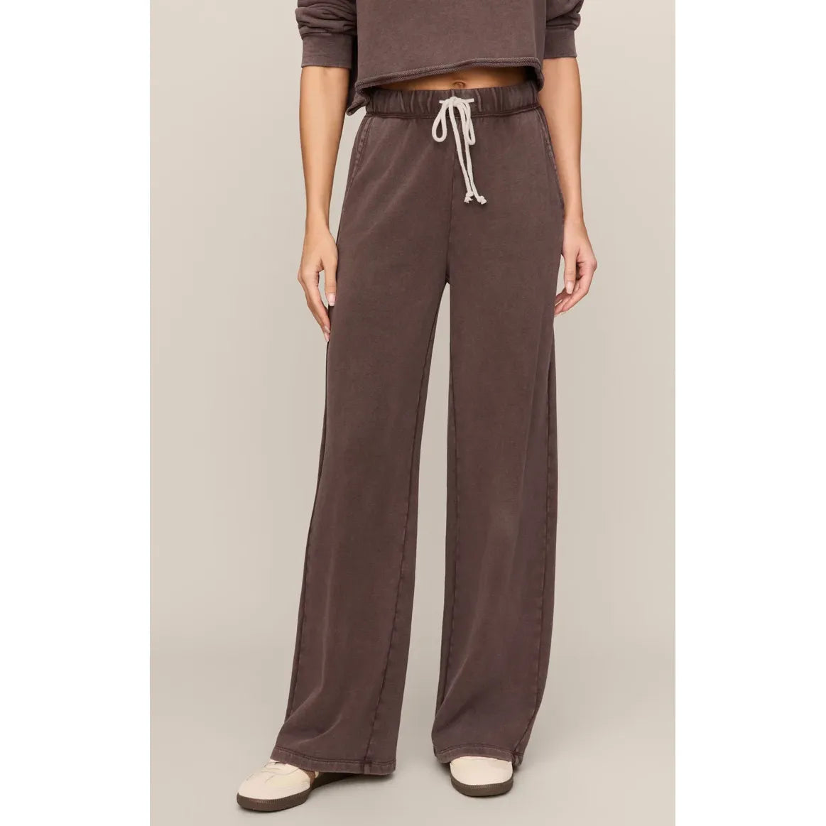 Brown wide-leg knit pants with white drawstring waist, slash pockets, and relaxed fit for comfortable daily wear.