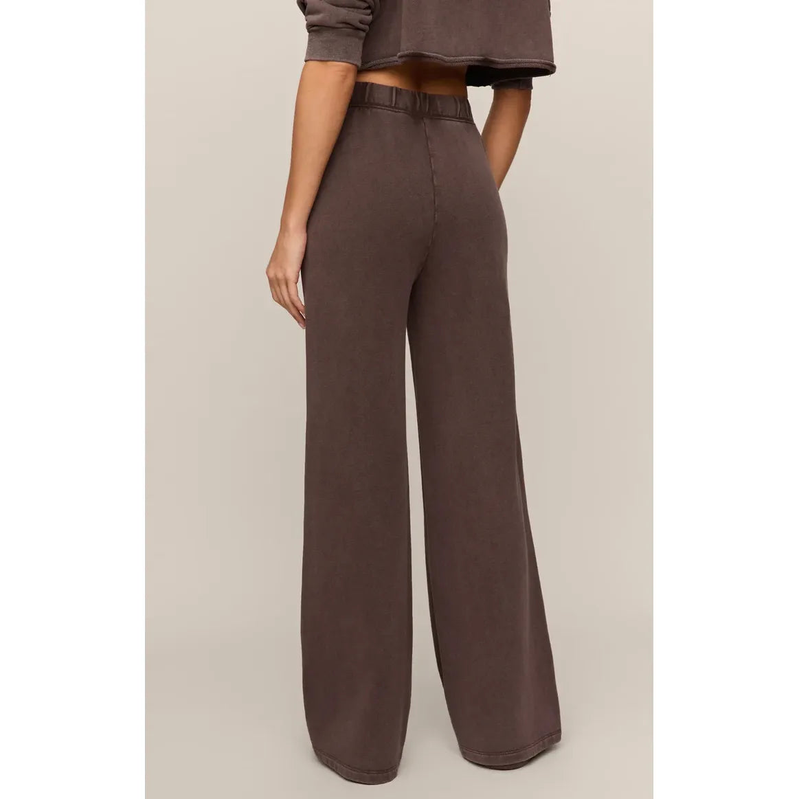 Brown wide-leg knit pants featuring an elastic waistband and relaxed fit, crafted from soft cotton terry for comfortable daily wear.