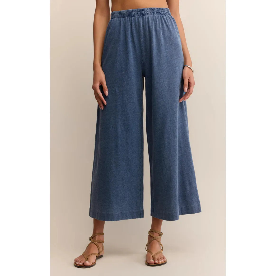 Z Supply Scout Jersey Denim Pant in vintage indigo, relaxed wide-leg with elastic waist and sandals