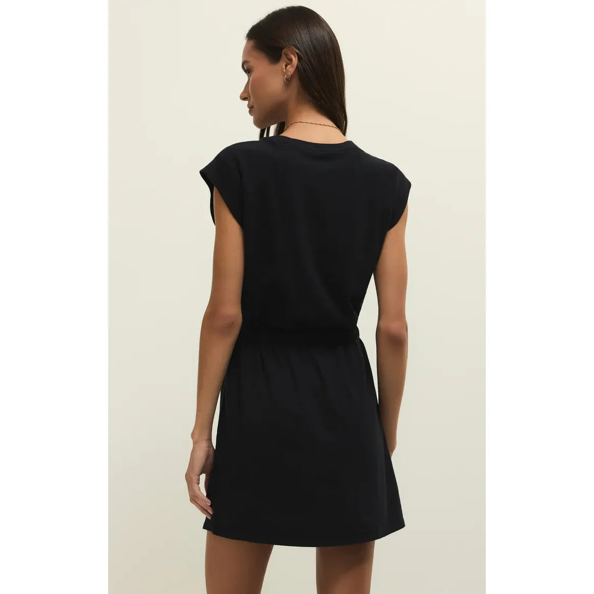 Back view of black Z Supply Kalani Mini Dress with elastic waist on a model.