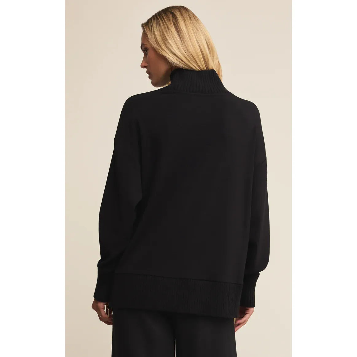 Back view of black Z Supply Sable Luxe Mock Neck Top with ribbed cuffs and hem.