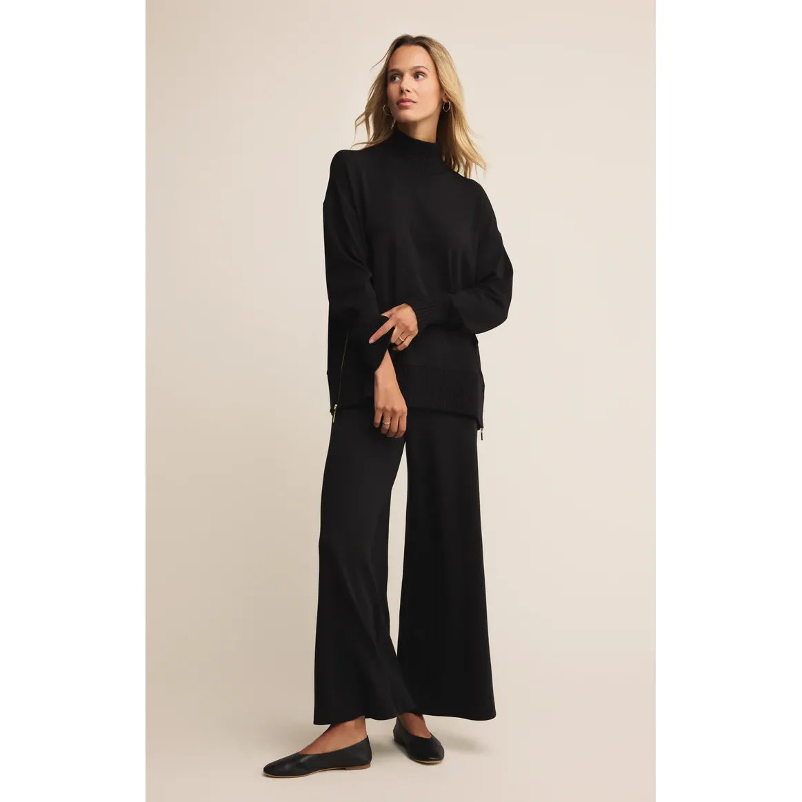 Model wearing Z Supply Sable Luxe Mock Neck Top in black, midweight knit with ribbed detailing and side zips.