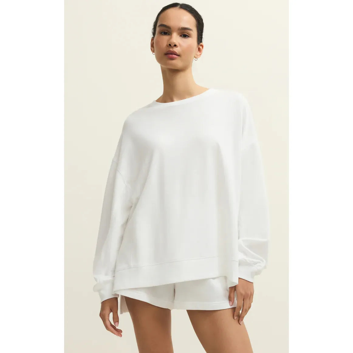 Model wearing white Z Supply Modern Weekender Sweatshirt with relaxed oversized fit in buttery soft baby French terry.