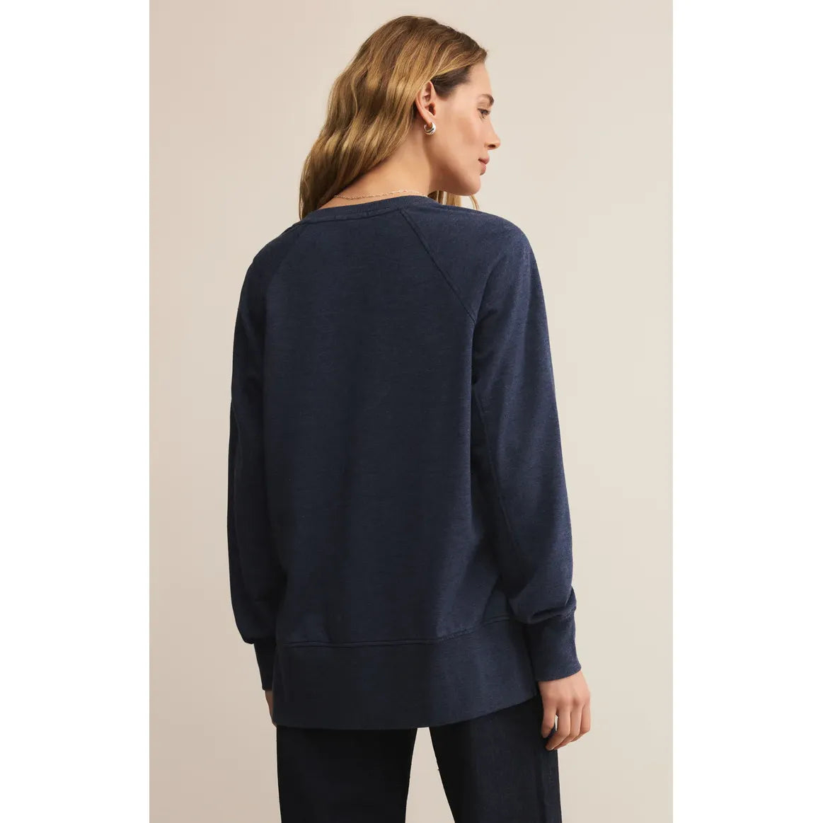 Back view of model in navy Z Supply Modern V-Neck Weekender Top, oversized long-sleeve.