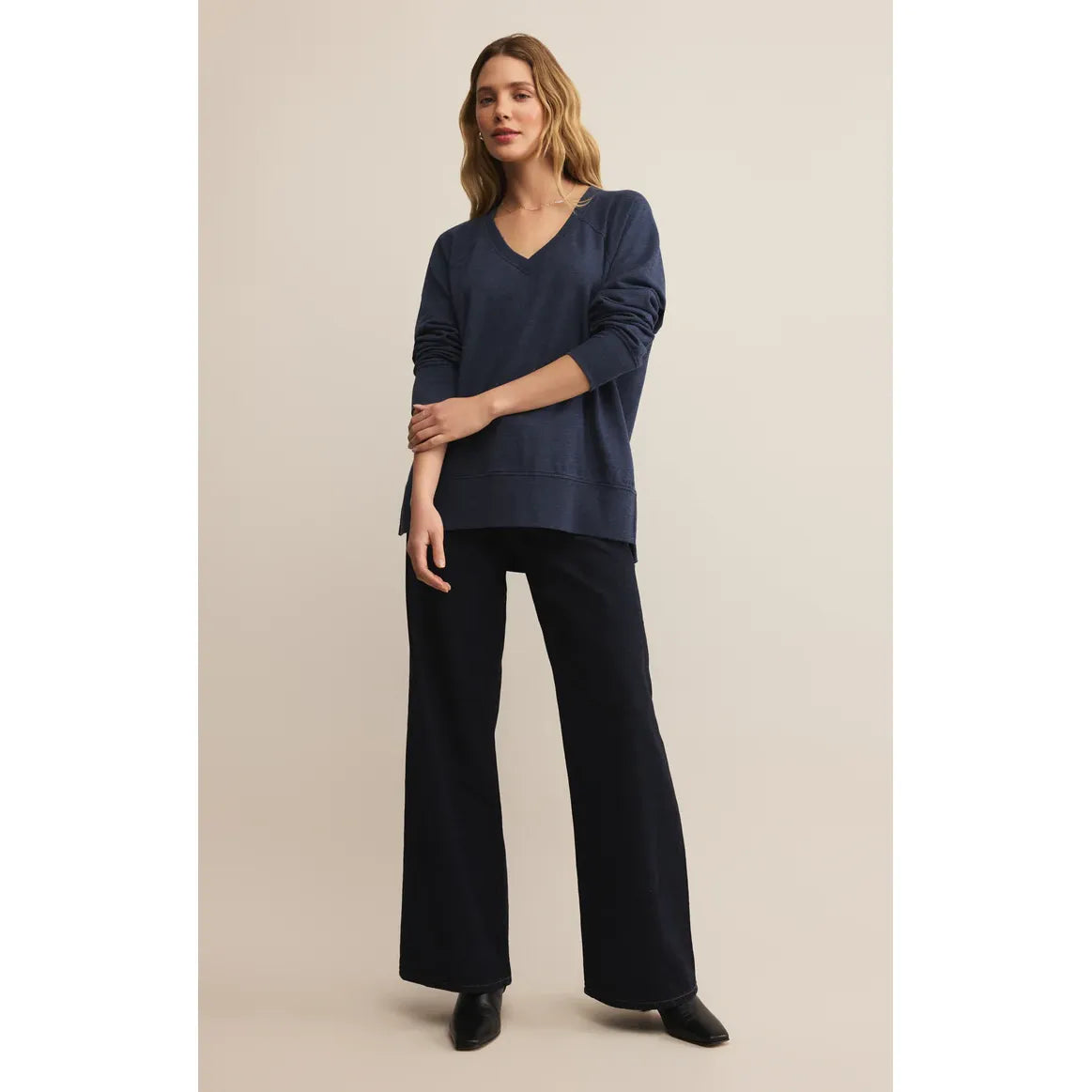 Z Supply Modern V-Neck Weekender Top in navy, oversized long sleeve with side slits and hi-lo hem on model