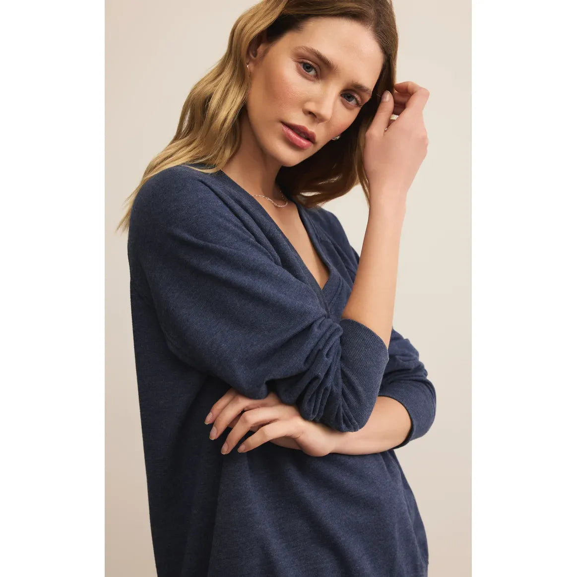 Model in navy Z Supply Modern V-Neck Weekender Top, oversized relaxed long-sleeve burnout knit.