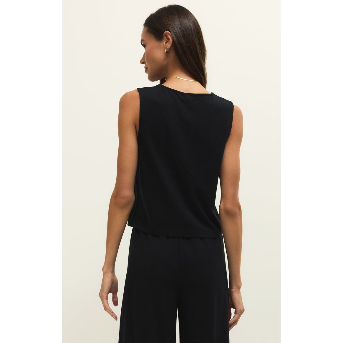 Back view of model wearing Z Supply Noelle Jersey Sleeveless Top in black.