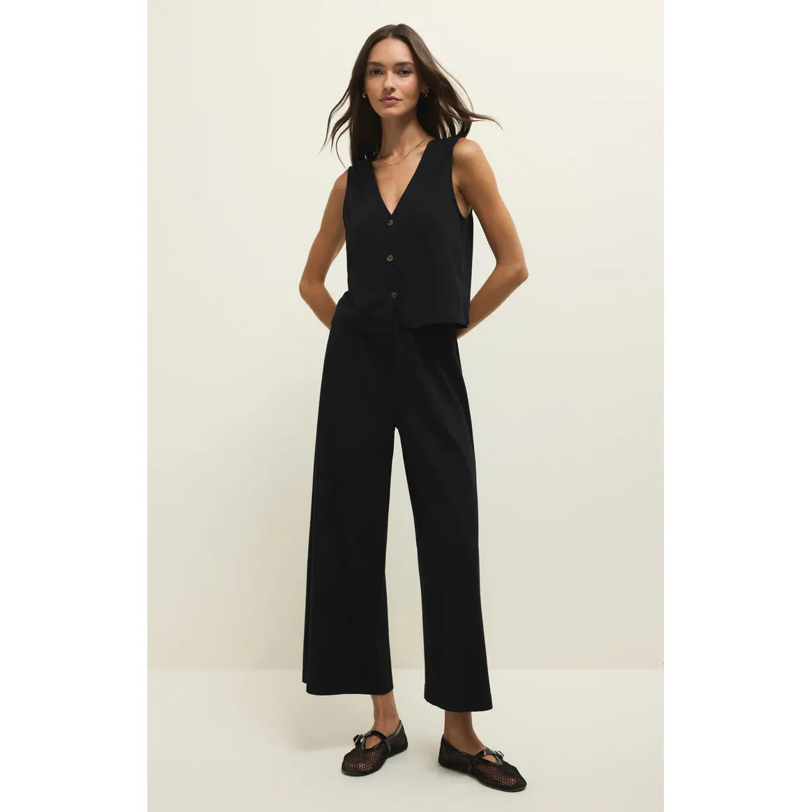 Z Supply Noelle Jersey Sleeveless Top with V-neck and button front, worn in black with matching wide-leg pants.