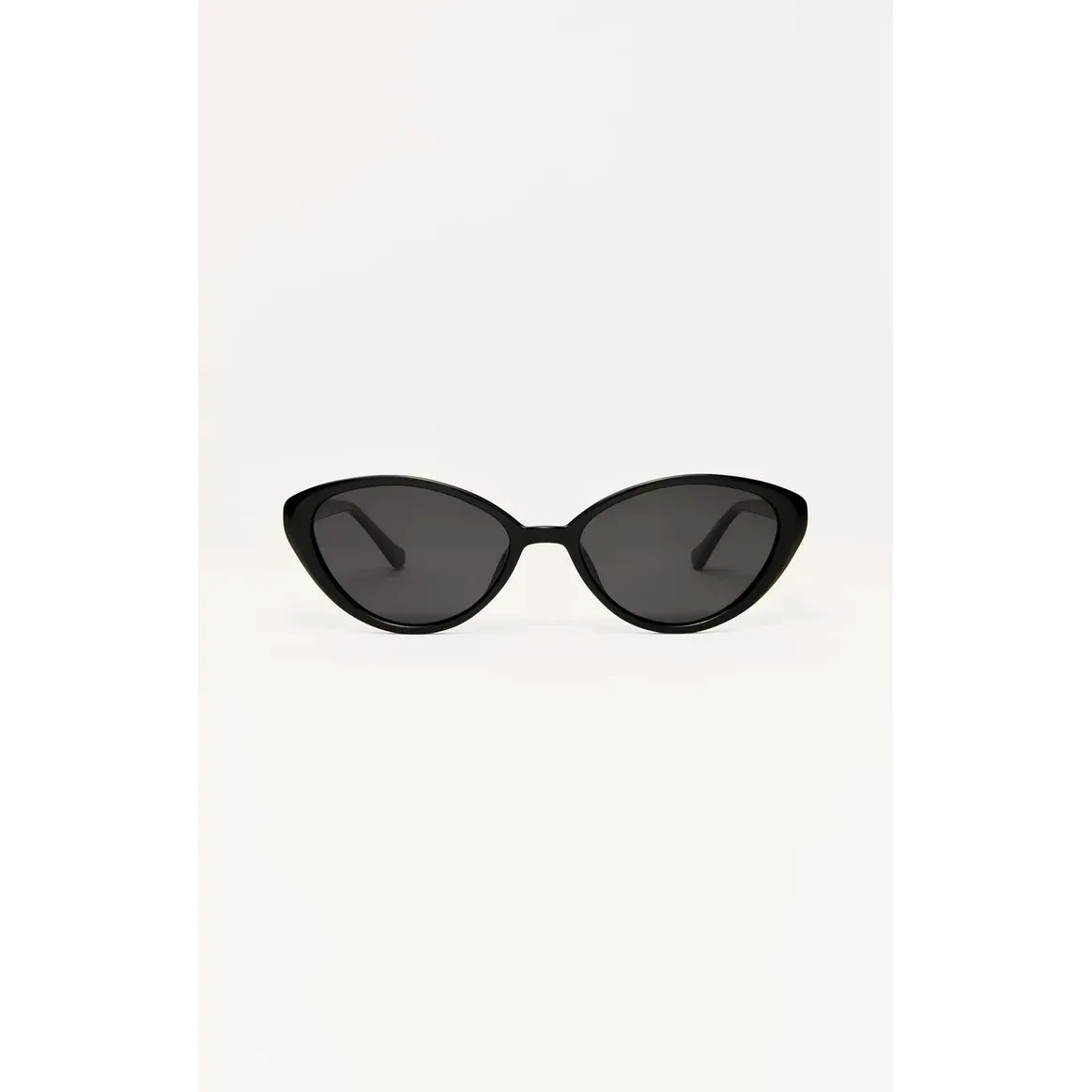 Woman wearing Z Supply Nouveau Sunglasses, mid-sized, sleek metal cat-eye frame with polarized lenses.