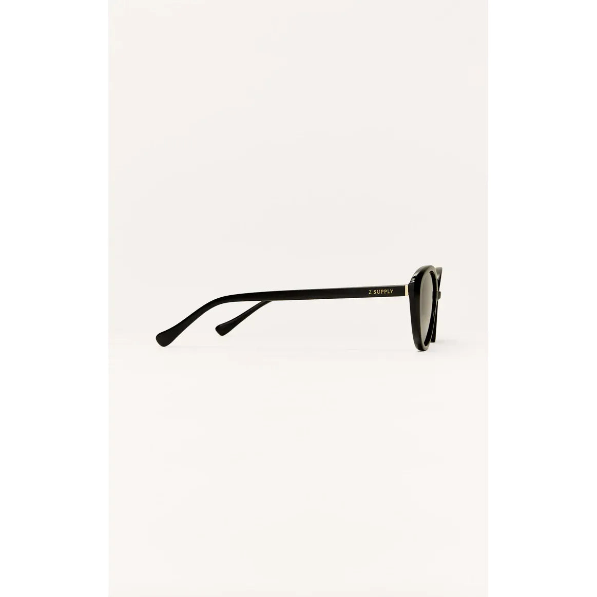 Z Supply Nouveau sunglasses with a black cat-eye frame, gold logo on the temple, and polarized lenses.