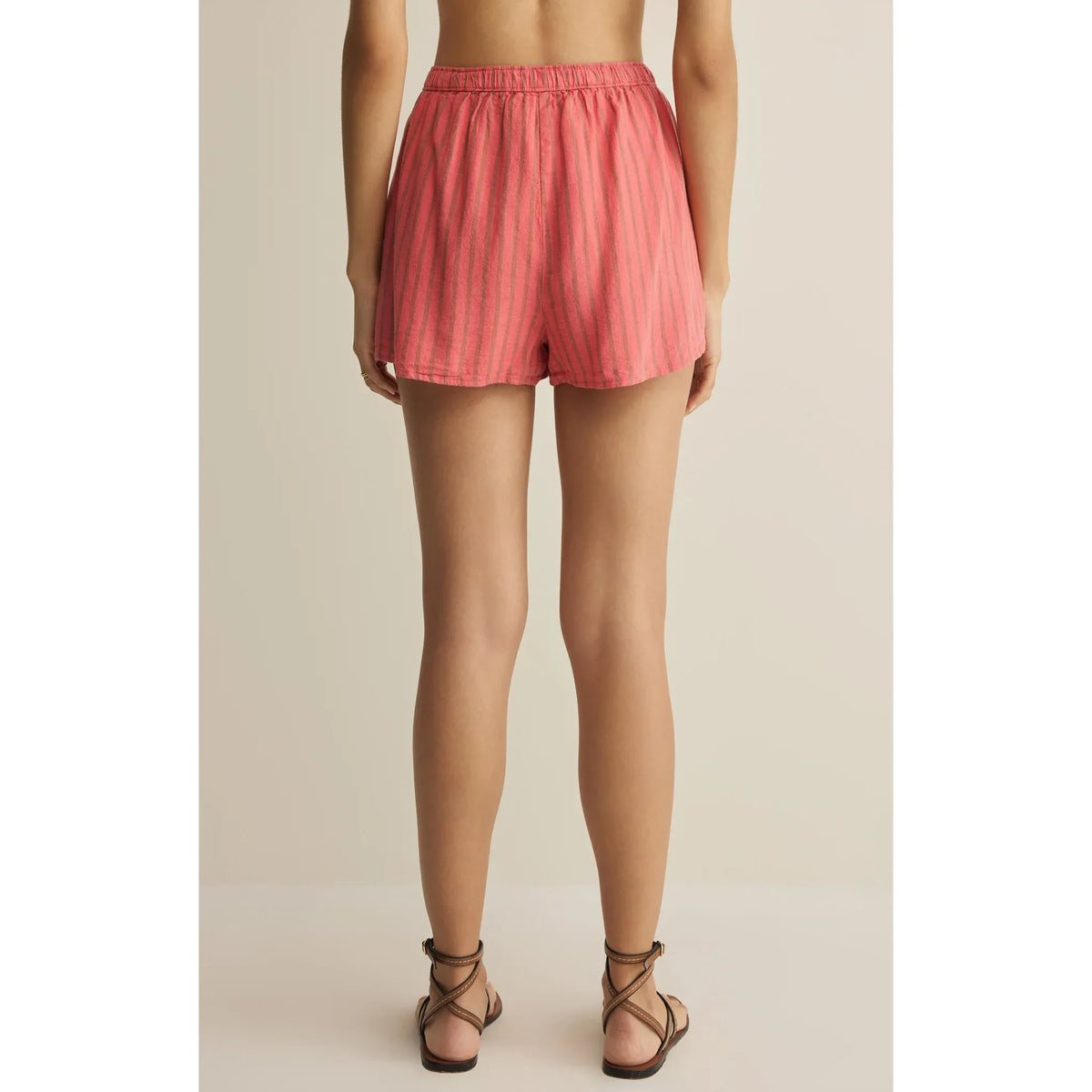 Back view of Z Supply The Perfect Linen Striped Short in pink with high-rise, drawcord waist and pockets.