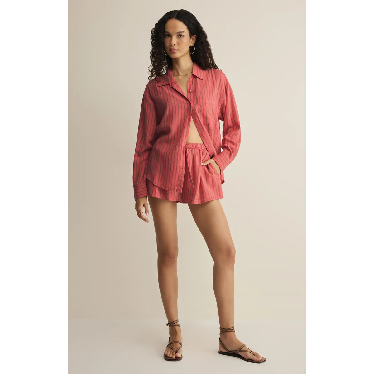 Model wearing Z Supply The Perfect Linen Striped Short set: pink striped long-sleeve shirt, matching shorts, sandals.