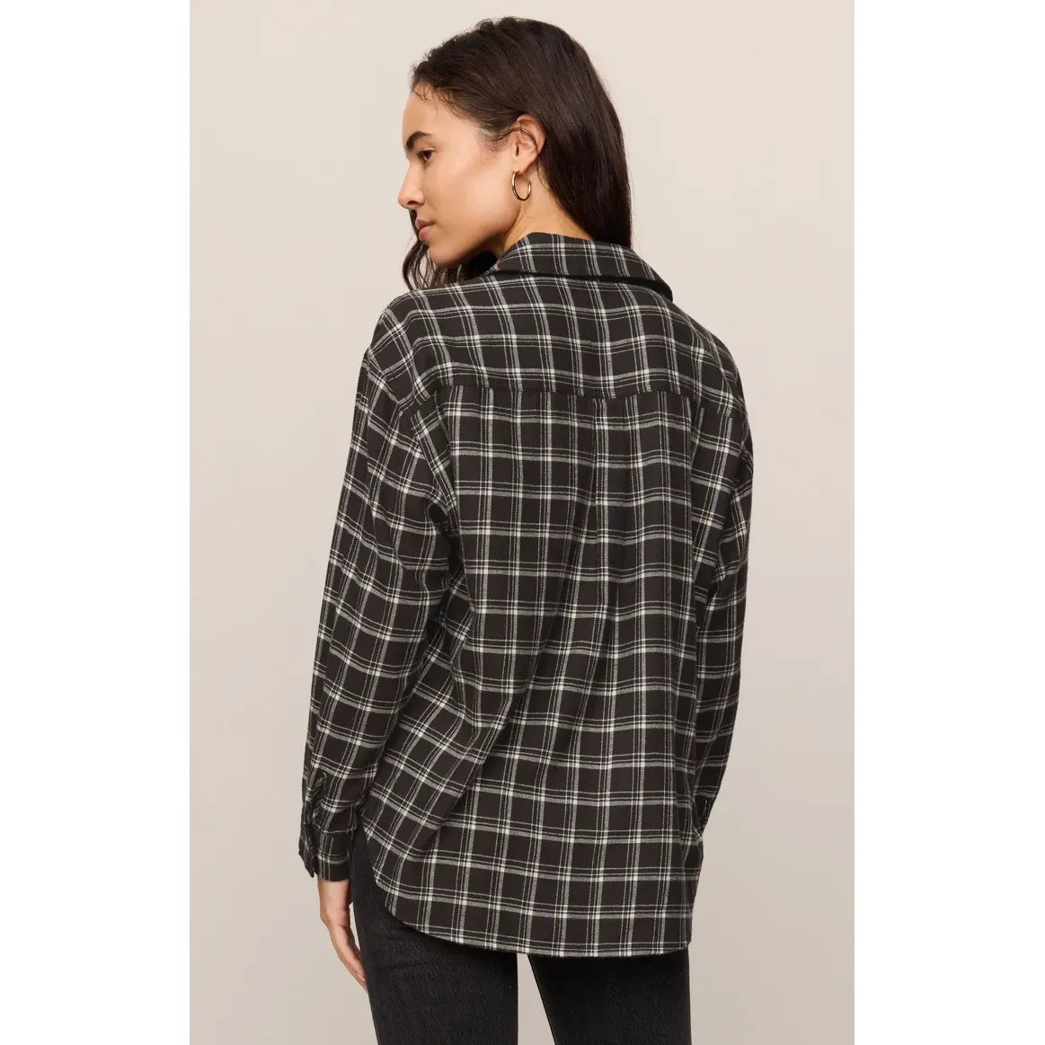 Back view of a woman wearing a chocolate cherry plaid button-up shirt with a relaxed fit and soft light brushed fabric.