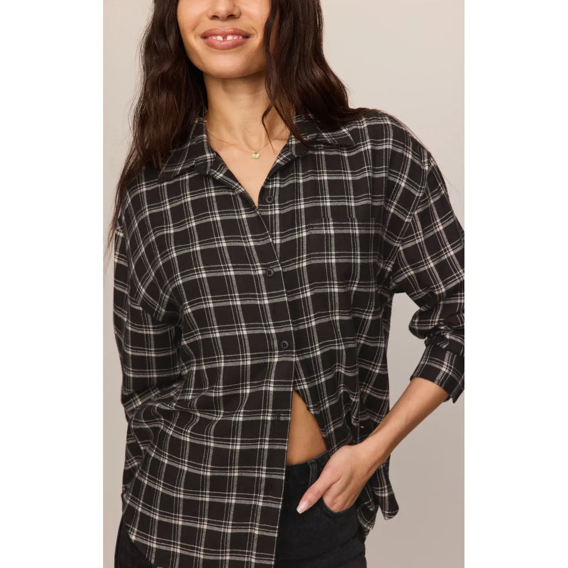 Model wearing Chocolate Cherry River Plaid Button Up, relaxed-fit black and white plaid shirt with rolled sleeves.
