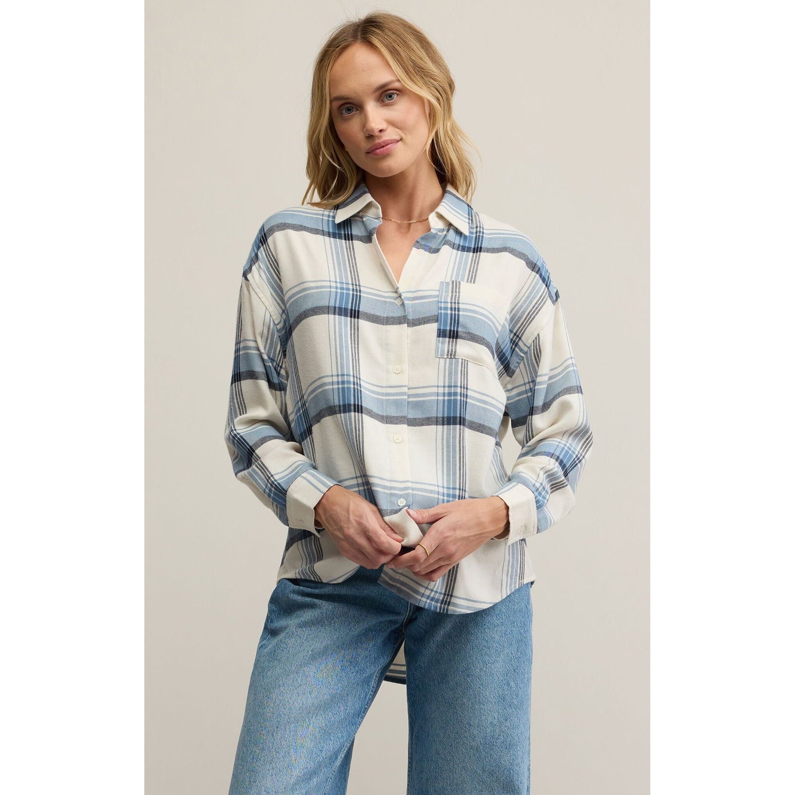 Z Supply River Plaid Button Up Top on a model, blue and white relaxed plaid collared shirt.